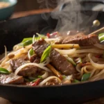 Beef ho fun cooking in wok with fresh ingredients