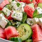Watermelon Cucumber Feta Salad in a bowl with mint and lime
